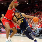 Michigan basketball player Roddy Gayle Jr. outperforms an OSU opponent for victory against the Buckeyes in Feb. 2025